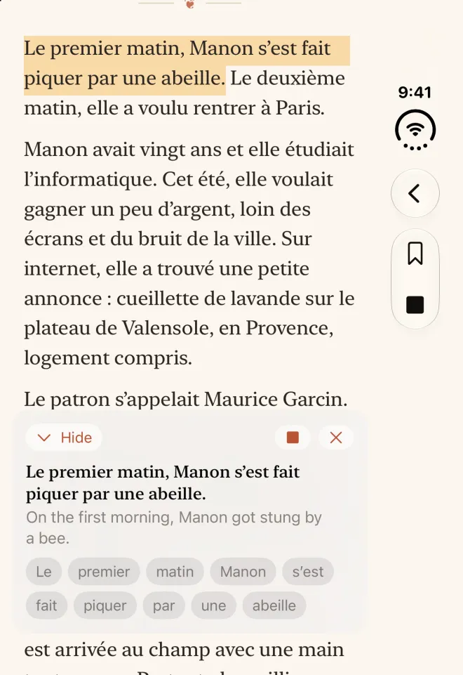 The cover screen of a closed iPhone Duo, showing La cueillette de lavande in French on a single page. The sentence “Le premier matin, Manon s’est fait piquer par une abeille.” is highlighted as it’s read aloud, and a panel at the bottom shows it with our English, “On the first morning, Manon got stung by a bee,” and each French word as a button.